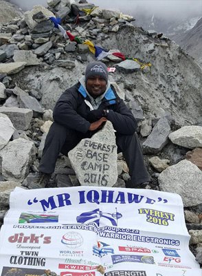 Donavan Pillay, Mr Iqhawe, at Everest Base Camp in 2016 with the Iqhawe Group banner